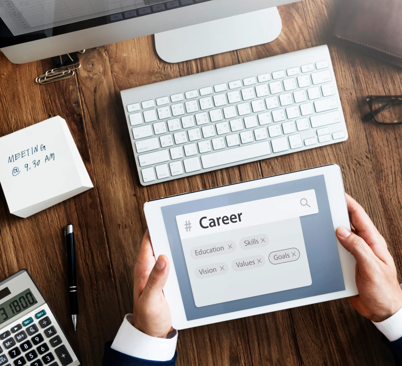 Desk with keyboard and tablet showing a 'Career' search bar.